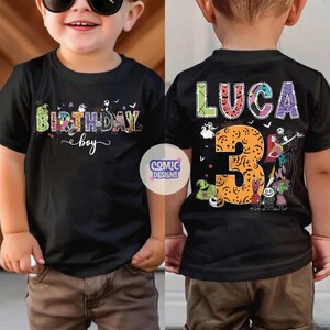 May include: A black t-shirt featuring a graphic print with the text BIRTHDAY boy on the front and the name LUCA with the number 3 on the back. The design includes colorful, patterned letters and various animated characters from a movie theme.