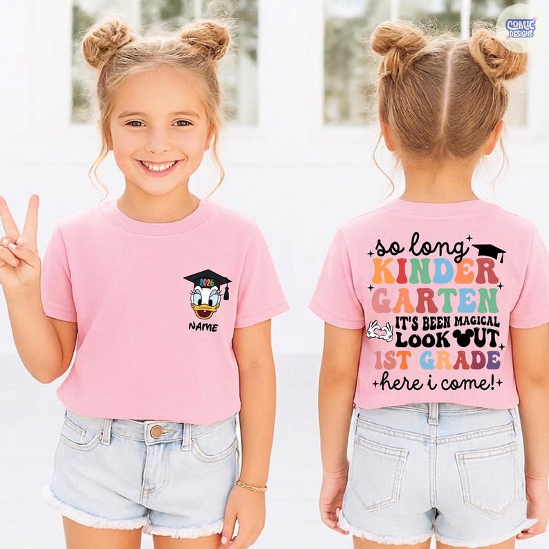 May include: A pink t-shirt with a Donald Duck graphic wearing a graduation cap and the text "2026" and "NAME". The back of the shirt says "So long Kindergarten, It's been magical, 1st Grade, here I come!"