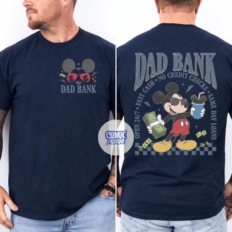May include: Navy blue t-shirt with a front graphic of Mickey Mouse ears, dollar signs, and the words "DAD BANK." The back features Mickey Mouse with cash, a drink, and the words "DAD BANK" and "OPEN 24/7 FAST CASH NO CREDIT CHECKS SAME DAY LOANS."