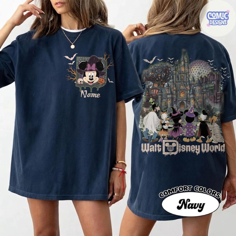 May include: A navy blue t-shirt featuring a front graphic of Minnie Mouse in a witch hat with the text Name. The back displays a detailed Halloween-themed Walt Disney World illustration with various characters in costumes and the text Walt Disney World.
