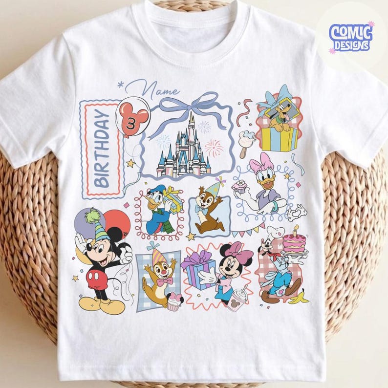 May include: White t-shirt featuring a colorful birthday design with Disney characters like Mickey Mouse, Minnie Mouse, Donald Duck, and Chip and Dale. The design includes a castle, balloons, and the word "Birthday". The shirt has the text "Comic Designs".