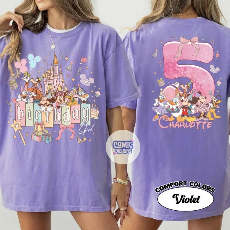 May include: A violet-colored t-shirt featuring a birthday design with cartoon characters and the text "Birthday Girl" on the front. The back of the shirt displays a large number "5" with a bow and the name "Charlotte".