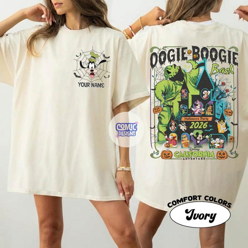 May include: Ivory-colored t-shirt featuring a cartoon of Goofy in a spiderweb with the text "YOUR NAME". The back of the shirt has a graphic for the "Oogie Boogie Bash" Halloween Party 2026 at Disney California Adventure.