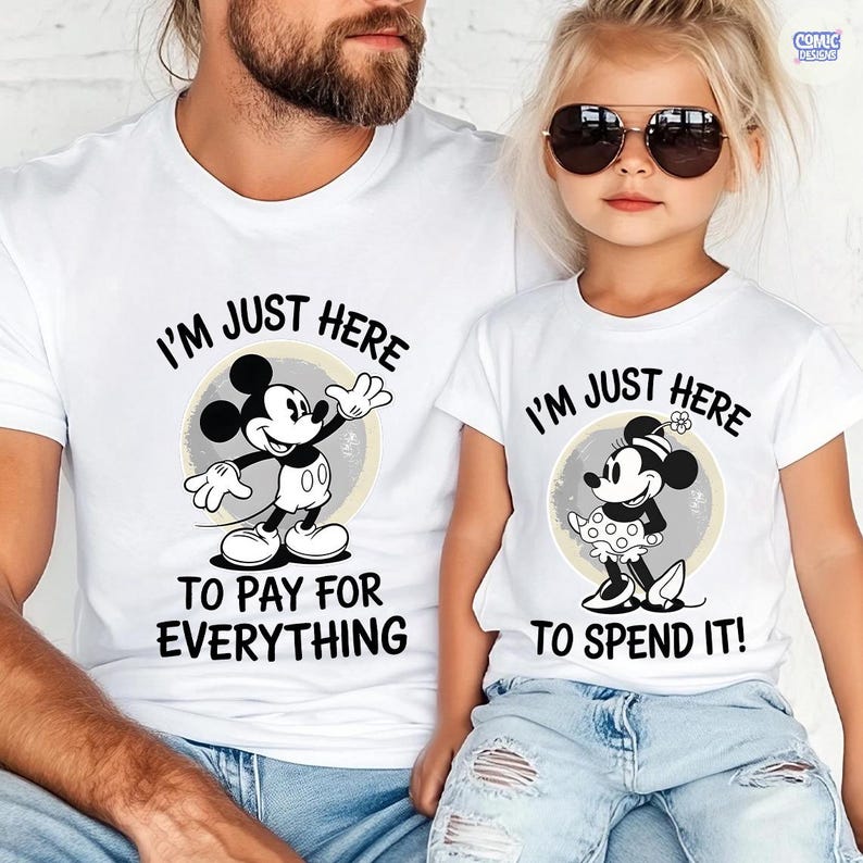 May include: White t-shirts with matching Mickey and Minnie Mouse designs. The shirts feature the text "I'M JUST HERE" above the characters, with "TO PAY FOR EVERYTHING" and "TO SPEND IT!" below. The designs are in black and white.
