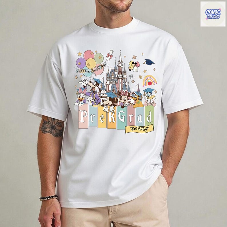 May include: White t-shirt featuring a colorful graphic of Disney characters, a castle, balloons, and the words "Prek Grad Daddy." The design includes Mickey Mouse, Minnie Mouse, Donald Duck, and other characters, with graduation-themed elements.