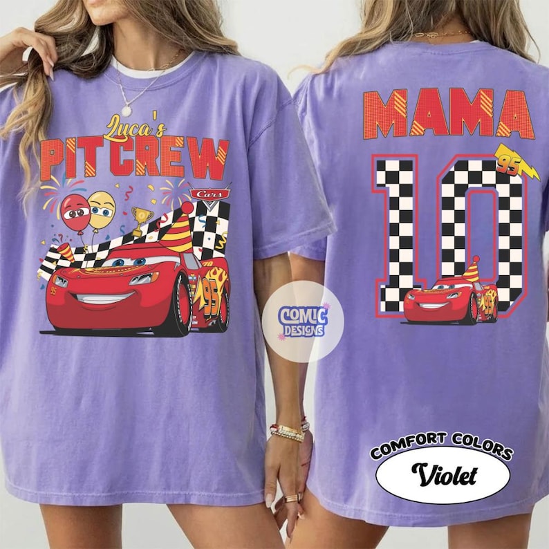 May include: A violet Comfort Colors t-shirt featuring a graphic of the Cars character Lightning McQueen. The front reads "Luca's Pit Crew" and the back displays "Mama 10". The design includes checkered flags and birthday elements.