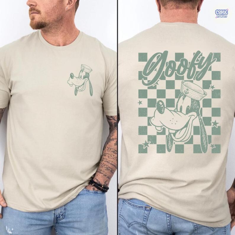 May include: Beige t-shirt with a green cartoon image of Goofy in a sailor hat on the front. The back of the shirt has a larger Goofy graphic with the word "Goofy" above a chequered pattern.