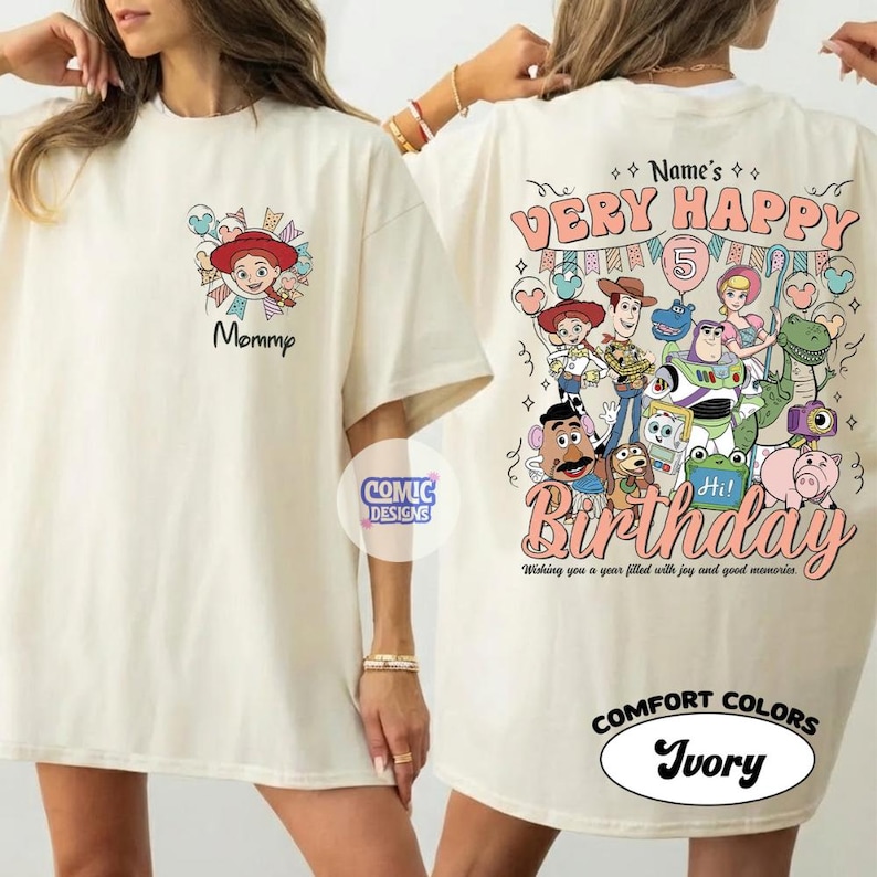 May include: Ivory-colored t-shirt featuring a cartoon graphic of a character with a red hat and the word "Mommy". The back of the shirt displays a "Very Happy Birthday" design with cartoon characters and the number 5.
