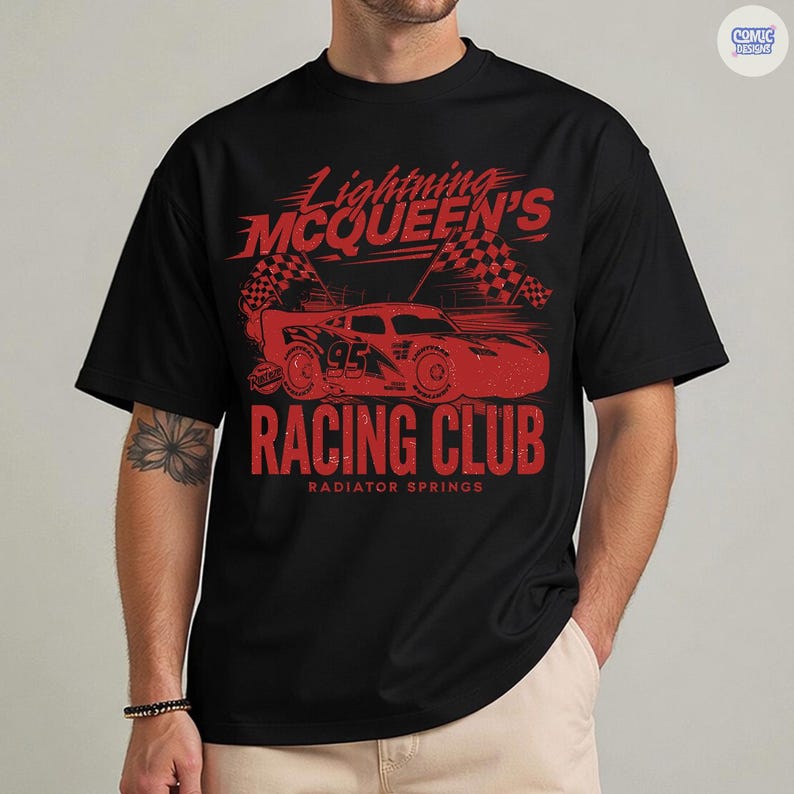 May include: Black t-shirt featuring a red graphic of Lightning McQueen's Racing Club. The design includes a race car, checkered flags, and the text "Racing Club, Radiator Springs". The shirt is a classic crew neck.