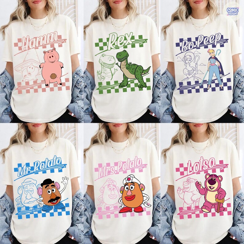 May include: A collection of six off-white t-shirts featuring Toy Story character graphics. Each shirt displays a name in cursive, a checkered border, and a colorful illustration of Hamm, Rex, Bo Peep, Mr. Potato Head, Mrs. Potato Head, or Lotso.