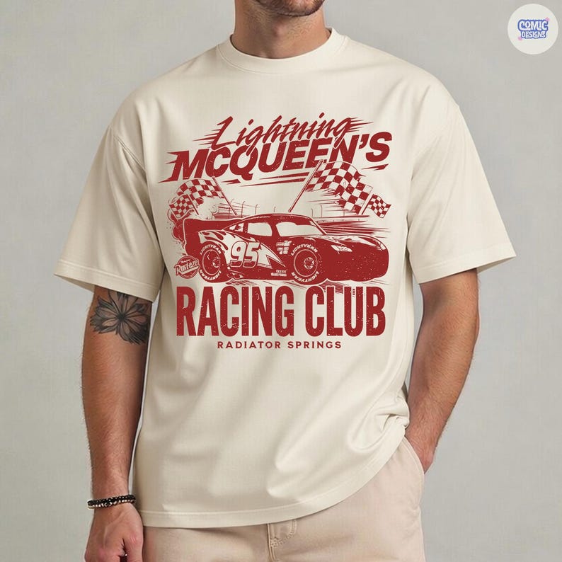 May include: Cream-colored t-shirt featuring a red graphic of Lightning McQueen's race car, the number 95, and checkered flags. The text reads "Lightning McQueen's Racing Club" and "Radiator Springs".