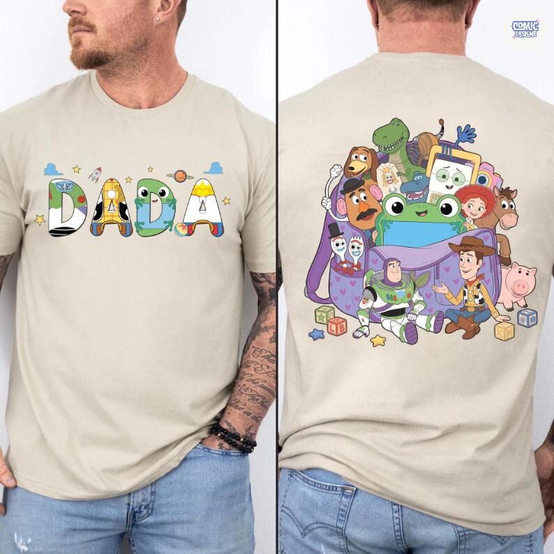 May include: A beige t-shirt featuring the word DADA on the front, with each letter styled after Toy Story characters. The back displays a purple backpack overflowing with various Toy Story characters, including Woody, Buzz Lightyear, and Rex.