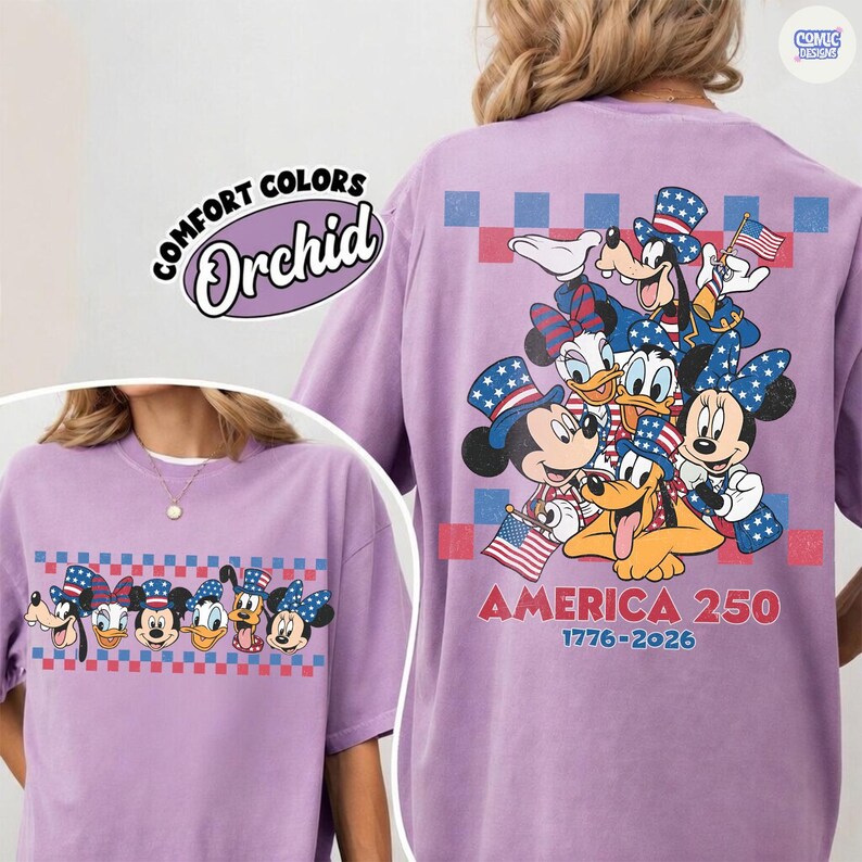 May include: Orchid-colored t-shirt featuring a graphic of Disney characters in patriotic attire, including Mickey and Minnie Mouse, Donald Duck, and Goofy. The shirt has the text "AMERICA 250 1776-2026" and "COMFORT COLORS" and "Orchid" printed on it.