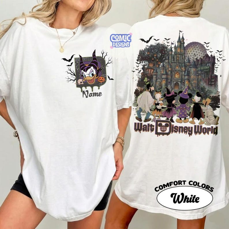 May include: A white t-shirt featuring a front graphic of Maleficent with the text Name and a back graphic of Disney characters in Halloween costumes in front of a castle with the text Walt Disney World and the Comic Designs logo.