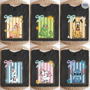 May include: Black t-shirts featuring cartoon characters within decorative frames. Designs include a mouse with cheese, a green chameleon, a yellow dog with a bone, an Olaf snowman, a pig, and a blue alien. Each frame has a bow.
