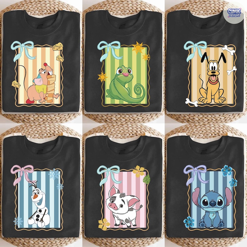 May include: Black t-shirts featuring cartoon characters within decorative frames. Designs include a mouse with cheese, a green chameleon, a yellow dog with a bone, an Olaf snowman, a pig, and a blue alien. Each frame has a bow.