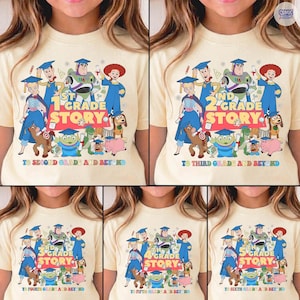 May include: A light yellow t-shirt featuring a colorful graphic of animated characters and the text "1st Grade Story" with the phrase "To Second Grade and Beyond". The design includes various cartoon figures.