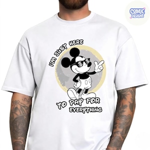 May include: White t-shirt featuring a black and white cartoon mouse wearing sunglasses with dollar signs. The text on the shirt reads "I'M JUST HERE TO PAY FOR EVERYTHING". The design is set against a light yellow circle.