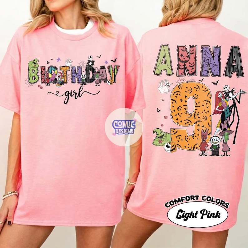 May include: A light pink t-shirt featuring a front graphic with the text Birthday girl and various cartoon characters. The back graphic displays the name Anna, the number 9, and multiple characters from The Nightmare Before Christmas movie.