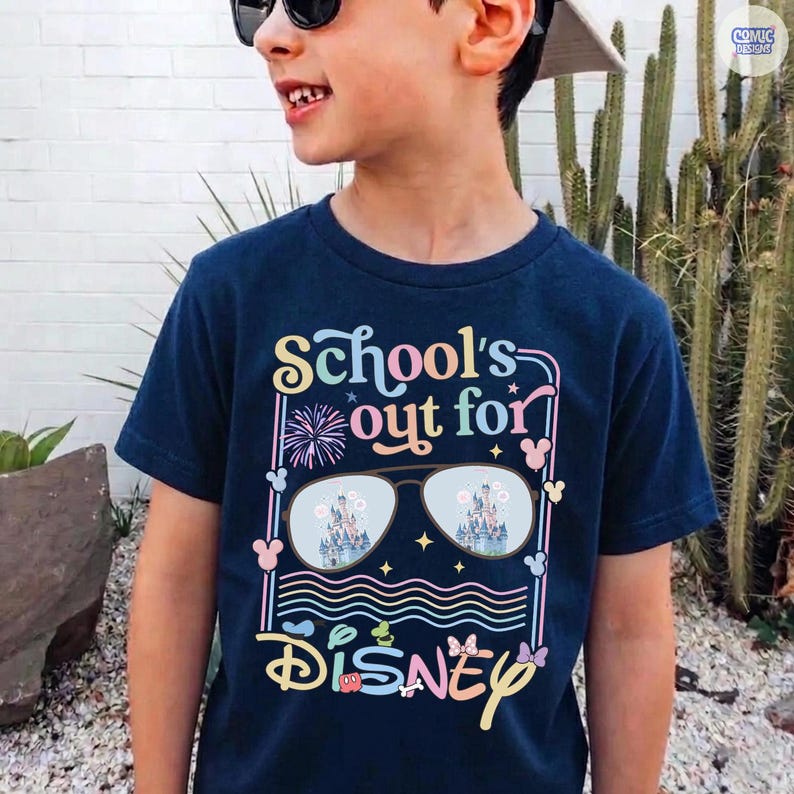 May include: Navy blue t-shirt with the text "School's out for Disney" in colorful, playful lettering. The design includes sunglasses reflecting a castle scene, fireworks, and Mickey Mouse silhouettes. A fun, themed shirt for kids.