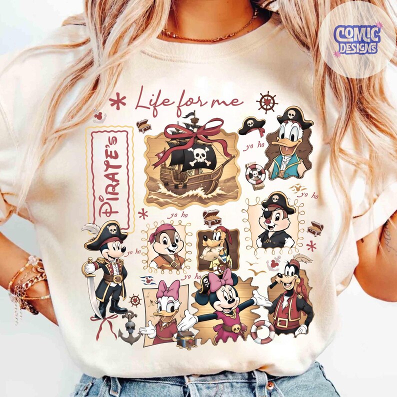 May include: Cream-colored t-shirt featuring a pirate-themed design with cartoon characters. The design includes a pirate ship, Mickey Mouse, Donald Duck, Chip and Dale, and other characters. Text includes "Life for me" and "Pirate's".