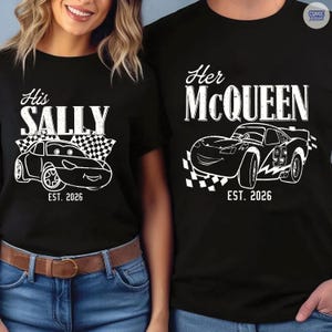 May include: Black t-shirts with white graphics. One shirt says "His Sally" with a car graphic and "EST. 2026". The other says "Her McQueen" with a car graphic and "EST. 2026".