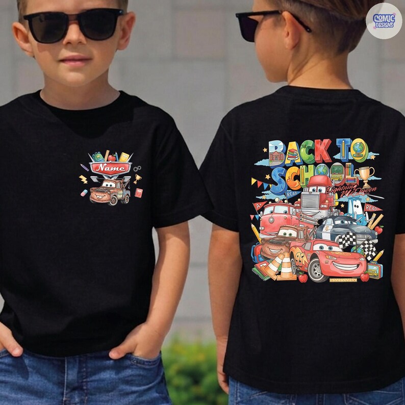 May include: A black t-shirt featuring a small graphic on the front chest of a brown tow truck with the text Name. The back displays a large, colorful illustration of various cartoon cars with the text Back To School and Lightning McQueen.