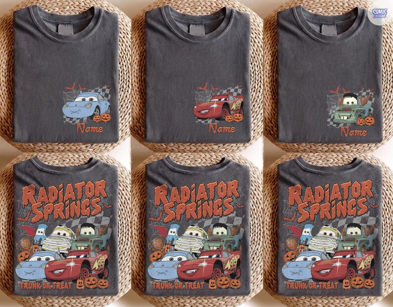 May include: A collection of dark grey t-shirts featuring Disney Pixar Cars characters in Halloween costumes. Some shirts show individual cars with the text Name, while others display the full group with the text Radiator Springs Trunk or Treat.