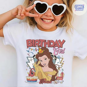 May include: White t-shirt with a colorful graphic featuring the text "BIRTHDAY Girl" and a cartoon image of a princess. The number "6" is displayed on a cake. The shirt is designed for a child.
