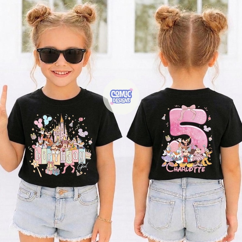 May include: Black t-shirt with a colorful birthday design featuring a castle, characters, and the text "Birthday Girl". The back of the shirt displays a large pink number 5 with characters and the name "Charlotte".