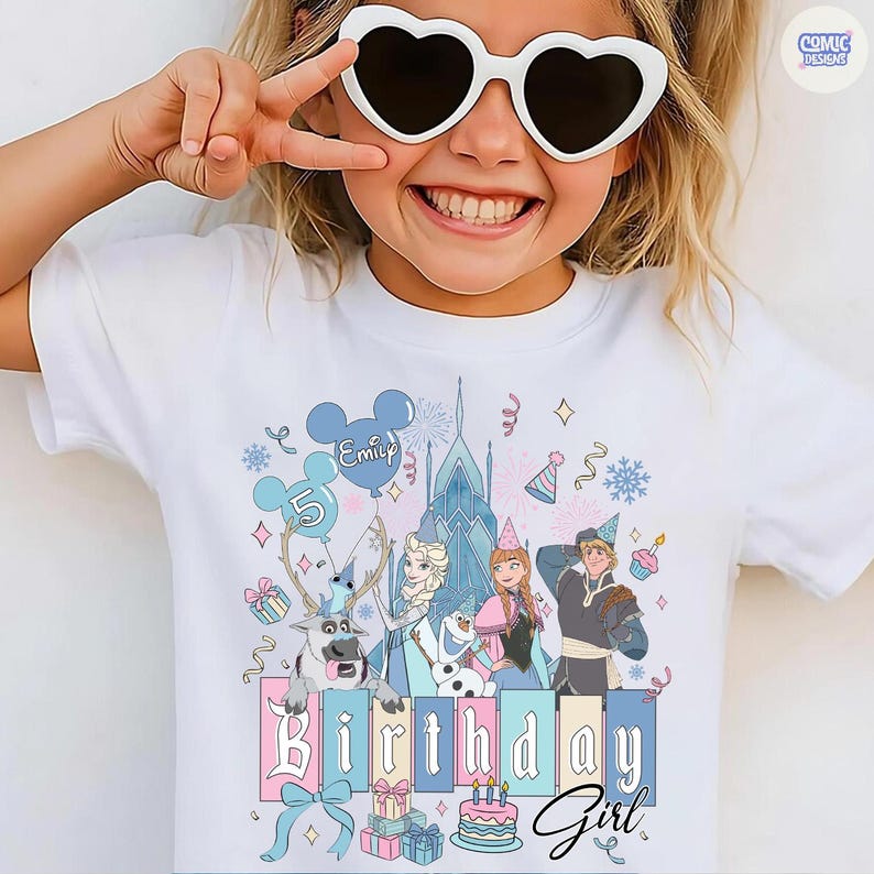 May include: White t-shirt featuring a colorful graphic of characters from a popular animated movie. The design includes the text "Birthday Girl" and a name on a balloon. The shirt has a festive birthday theme.