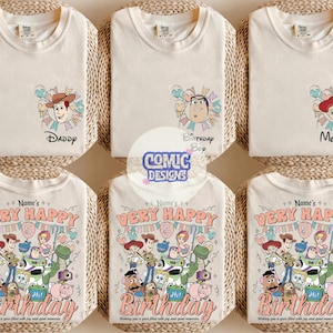 May include: Cream-colored t-shirts with cartoon character designs. One shirt says "Daddy" with Woody, another says "Birthday Boy" with Buzz Lightyear, and a third says "Mommy" with Jessie. The bottom shirts have a "Very Happy Birthday" design.