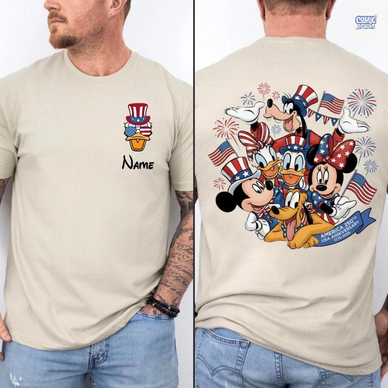May include: Tan t-shirt featuring a patriotic design. The front displays a stacked Uncle Sam hat, stars, and a duck wearing sunglasses, with the word "Name" below. The back showcases Disney characters Mickey, Minnie, Donald, Daisy, Goofy, and Pluto with flags and fireworks.