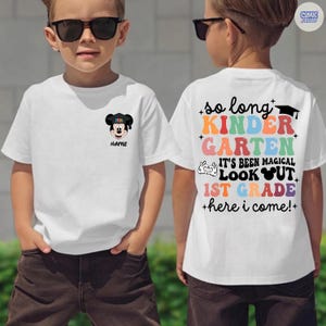 May include: White t-shirt with a Mickey Mouse graphic wearing a graduation cap and the text "NAME". The back of the shirt says "so long KINDERGARTEN, IT'S BEEN MAGICAL, LOOK OUT 1ST GRADE, +here i come!+"