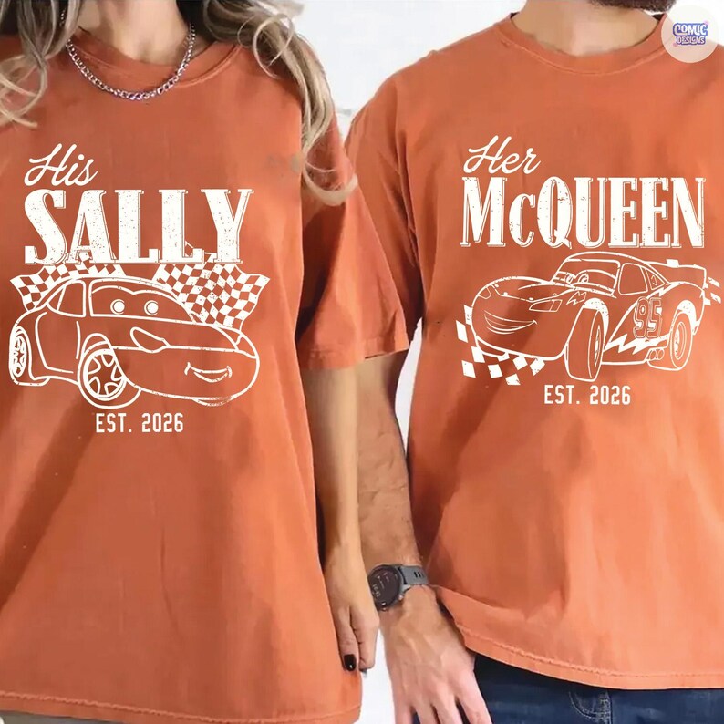 May include: Two burnt orange t-shirts with white graphics. One says "His SALLY" with a car illustration and "EST. 2026". The other says "Her McQUEEN" with a car illustration and "EST. 2026".