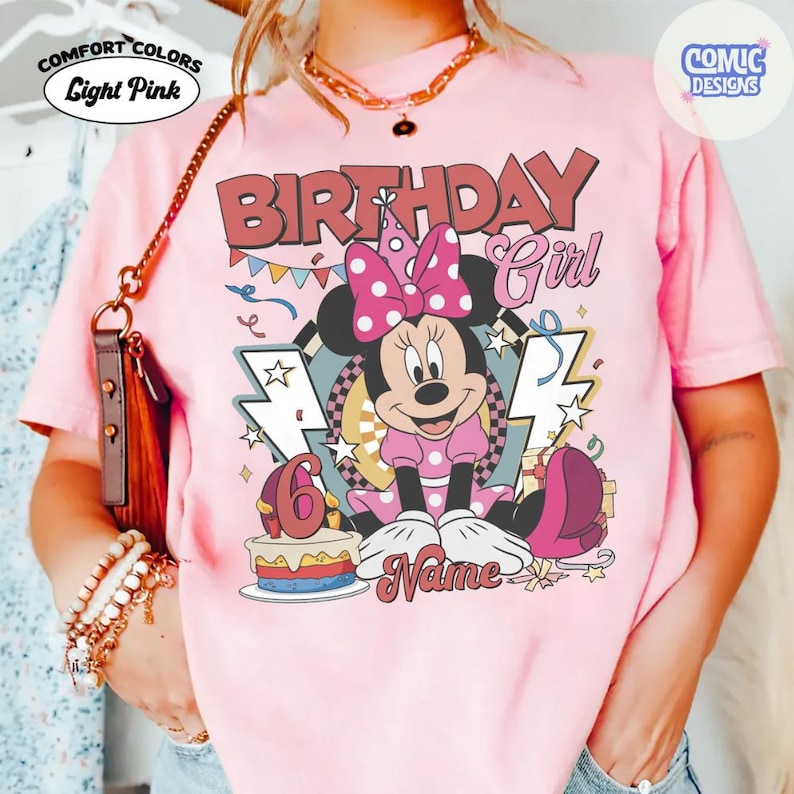 May include: Light pink Comfort Colors t-shirt with a Minnie Mouse graphic. The graphic includes the text "BIRTHDAY Girl" and "6", along with a cake and the word "Name". The design features a polka dot bow and lightning bolts.