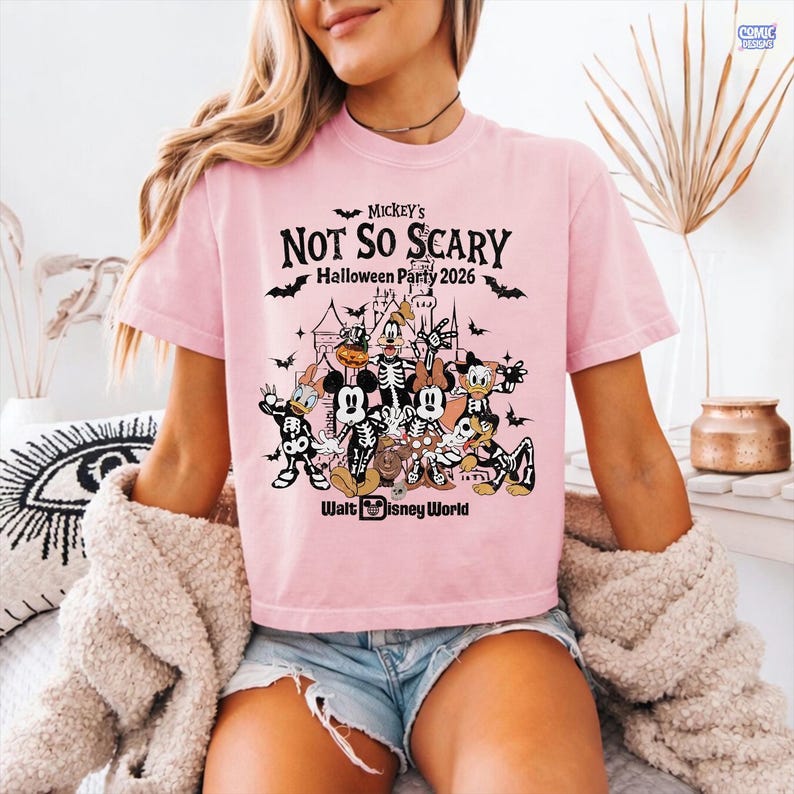 May include: A light pink t-shirt with the text "Mickey's Not So Scary Halloween Party 2026" and a graphic of Disney characters in skeleton costumes. The Walt Disney World logo is at the bottom of the graphic.