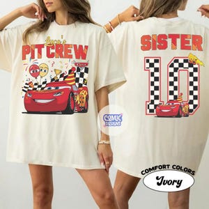 May include: Ivory-colored t-shirts with front and back graphics. The front features text "Luca's Pit Crew" and a red race car. The back says "Sister 10" with a checkered number 10 and a matching car graphic.