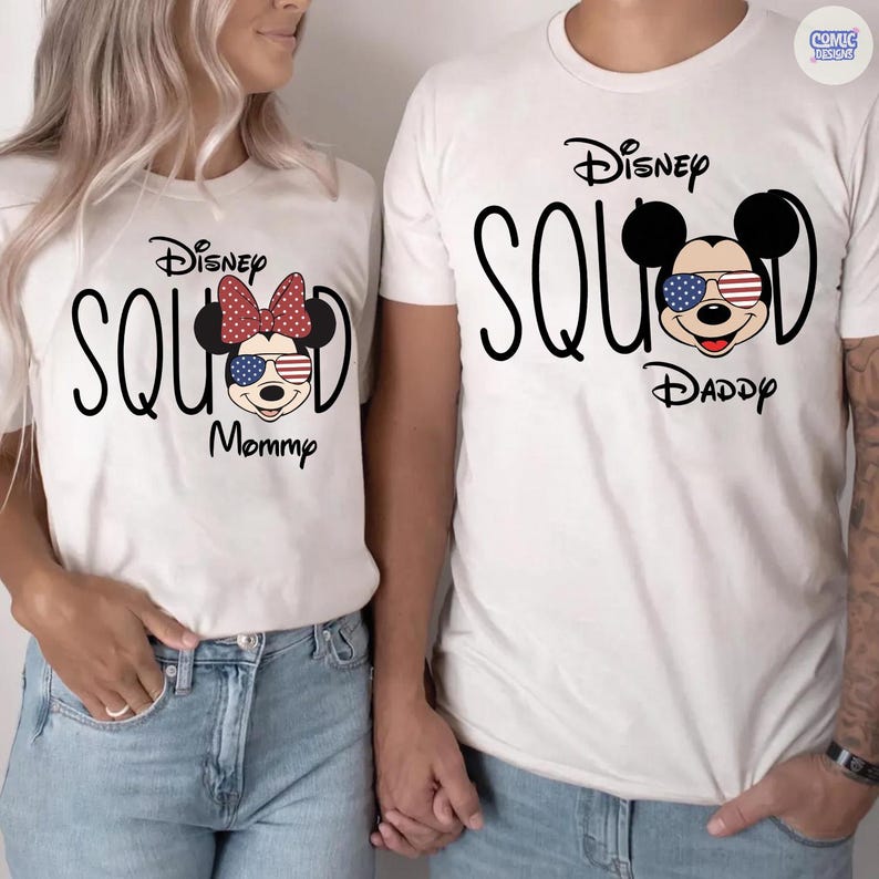 May include: Matching white t-shirts with the text "Disney Squad". One shirt features a Minnie Mouse design with a red bow and the word "Mommy". The other shirt has a Mickey Mouse design and the word "Daddy".