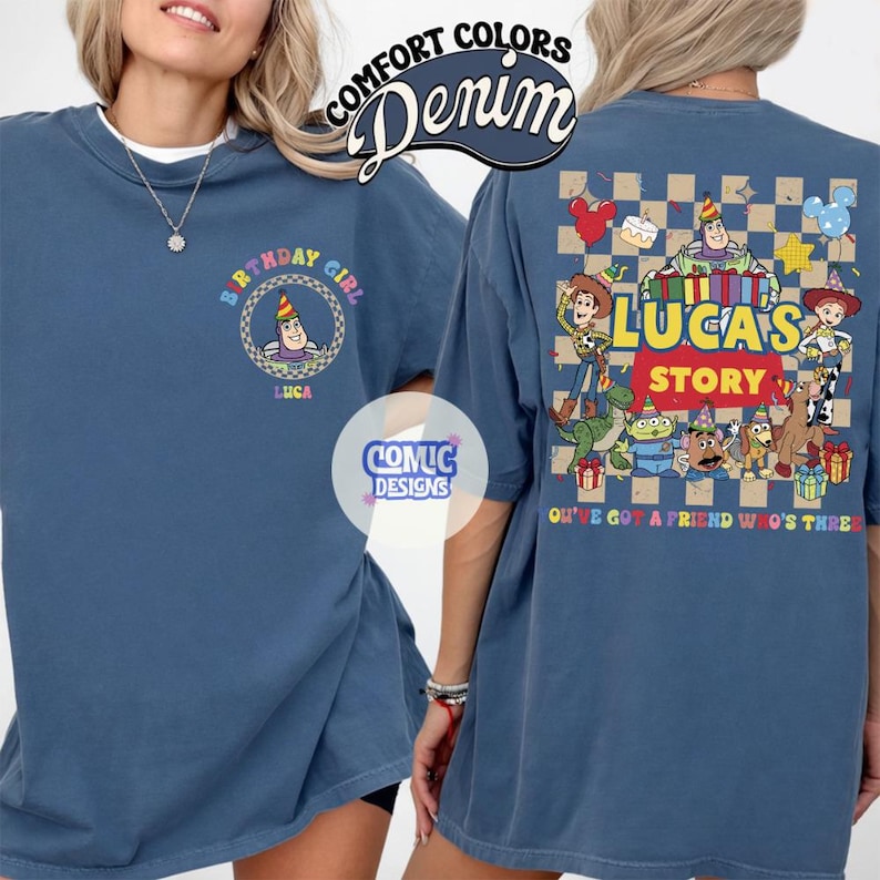 May include: Denim blue t-shirt with a graphic featuring a cartoon character wearing a party hat and the text "BIRTHDAY GIRL LUCA". The back of the shirt has a "Toy Story" theme with characters and the text "LUCA'S STORY".