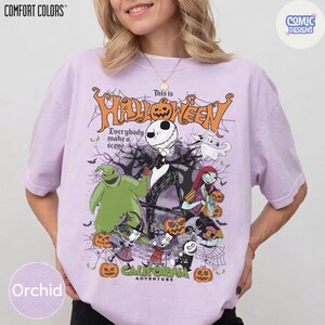May include: Orchid-colored t-shirt featuring a Halloween-themed graphic. The design includes Jack Skellington, Sally, and other characters from The Nightmare Before Christmas, with the text "This is Halloween".