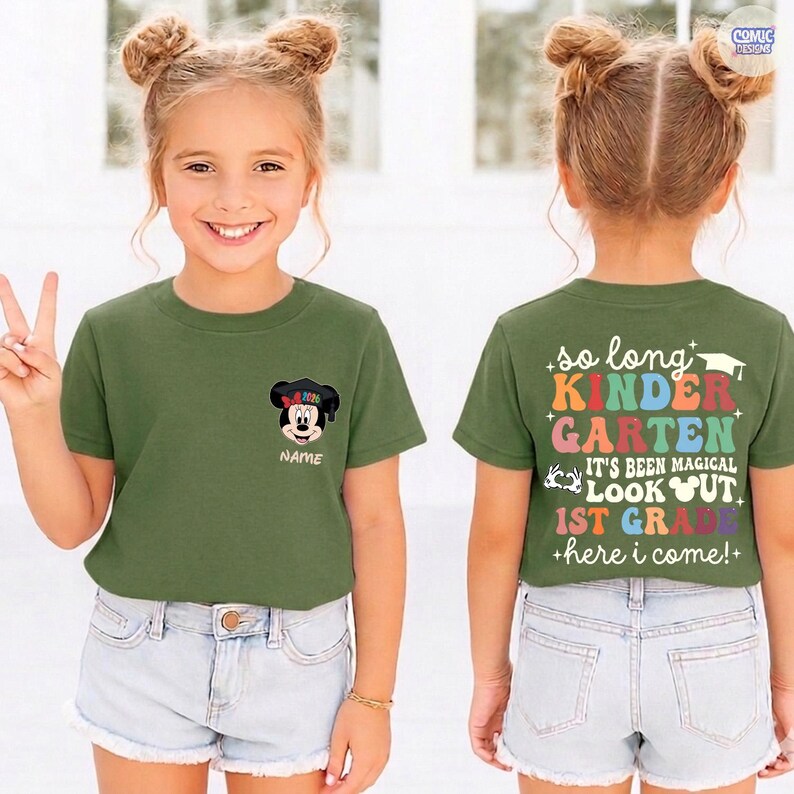 May include: Olive green t-shirt with a Mickey Mouse graphic wearing a graduation cap. The front of the shirt has the word "NAME" below the graphic. The back of the shirt says "so long KINDERGARTEN" and "1st GRADE".