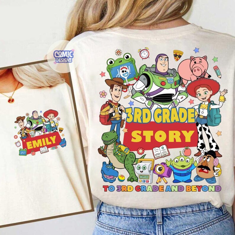 May include: A cream-colored t-shirt featuring a colorful graphic of Toy Story characters including Woody, Buzz Lightyear, Jessie, Rex, and Mr. Potato Head. The text reads 3RD GRADE STORY TO 3RD GRADE AND BEYOND with the name EMILY printed.