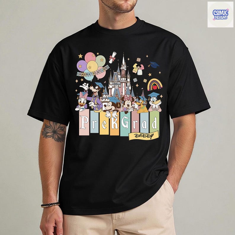 May include: Black t-shirt featuring a colorful graphic of Disney characters, a castle, balloons, and the text "Prek Grad Daddy." The design includes graduation caps and the word "Congratulations."