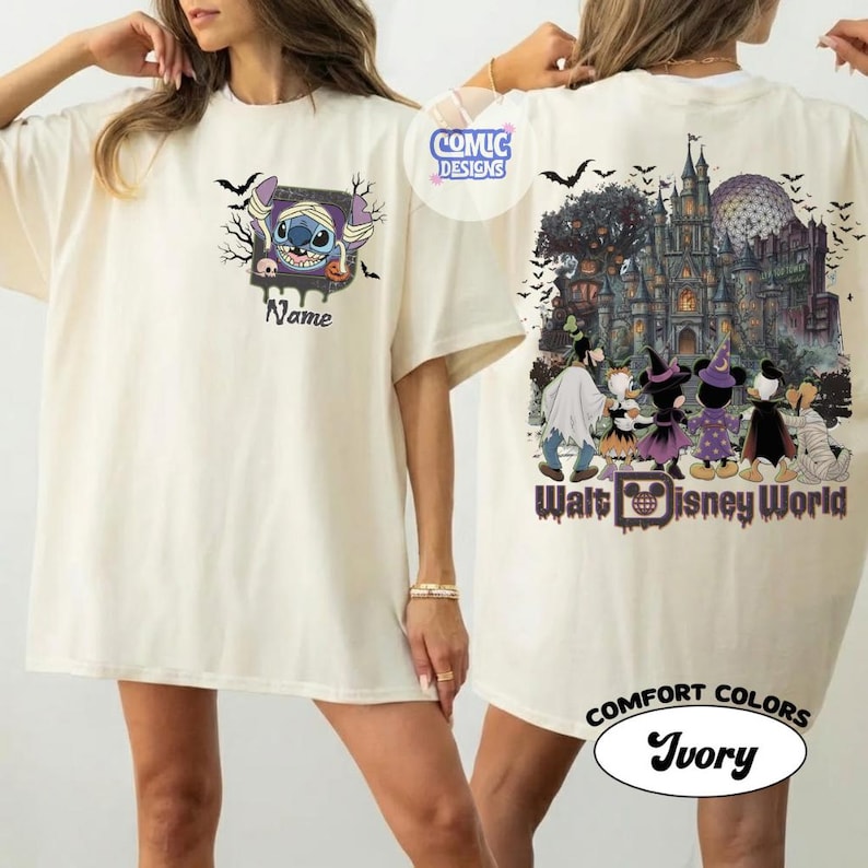 May include: An ivory t-shirt featuring a front graphic of Stitch wrapped like a mummy with the text Name. The back graphic displays a castle, bats, and cartoon characters in Halloween costumes with the text Walt Disney World and Comic Designs.
