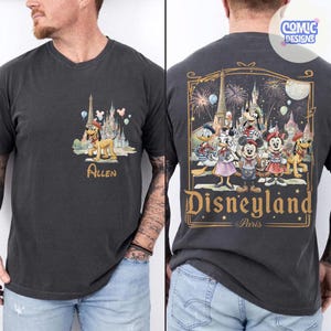 May include: A charcoal gray t-shirt featuring a small graphic on the front chest of Pluto in front of a castle with the name Allen below. The back displays a large illustration of Mickey, Minnie, Donald, Daisy, and Goofy at Disneyland Paris.