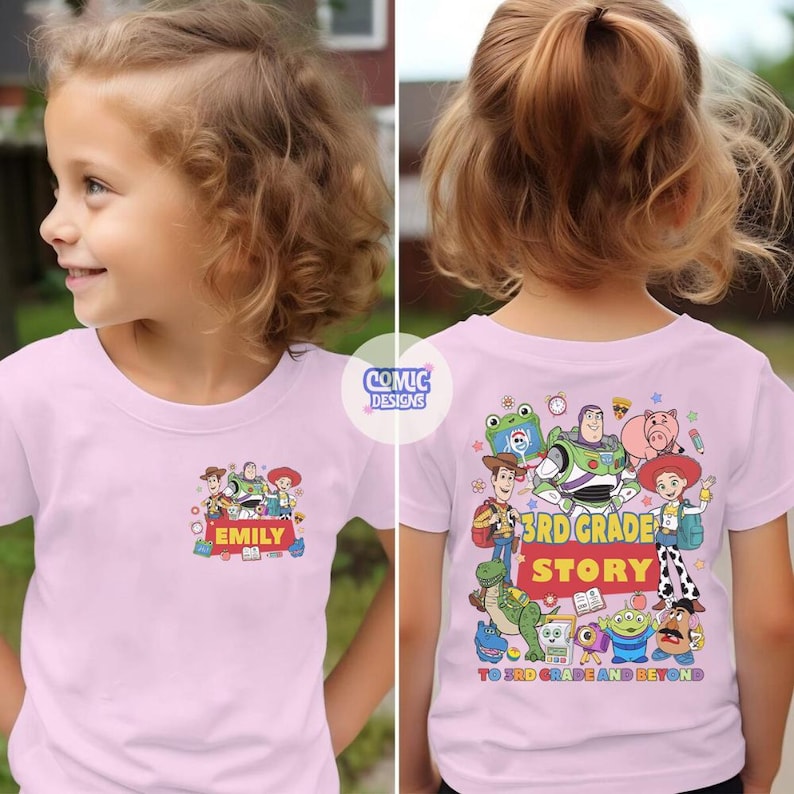 May include: A light pink t-shirt featuring Toy Story characters on the front and back. The front has a small graphic with the name EMILY. The back displays a large group of characters with the text 3RD GRADE STORY and TO 3RD GRADE AND BEYOND.