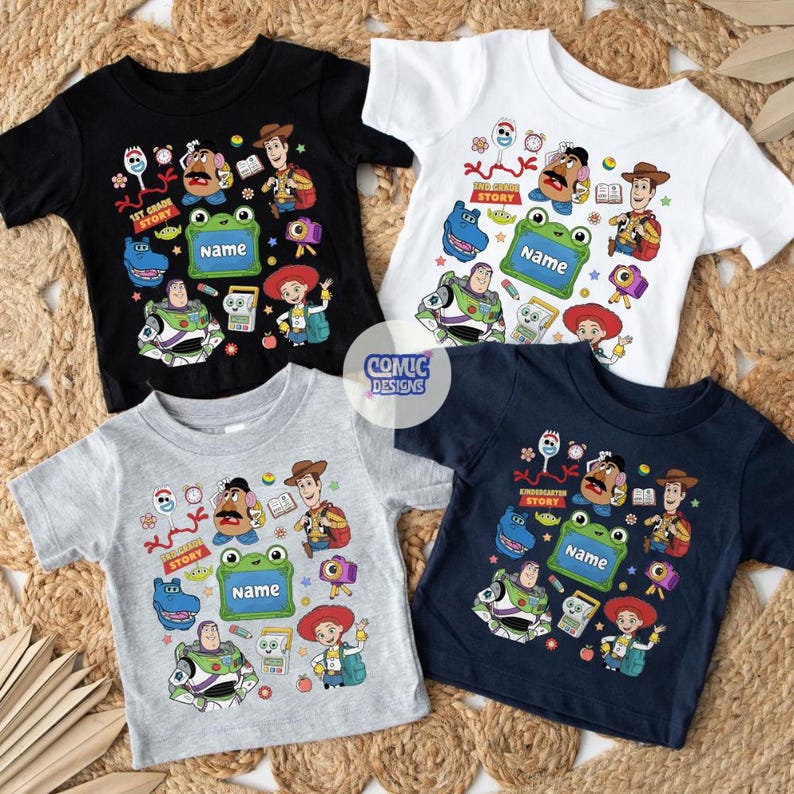 May include: Four short-sleeve t-shirts in black, white, gray, and navy blue, each featuring a colorful graphic print of cartoon characters including a cowboy, space ranger, potato figure, and a green frog frame with the text Name.