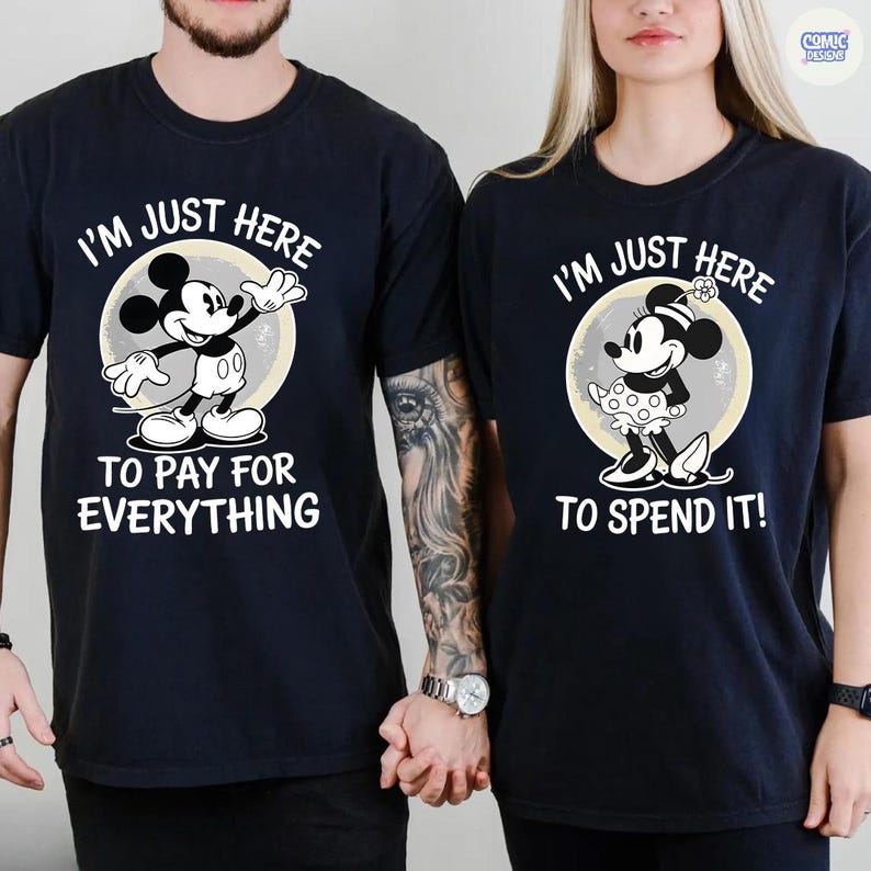 May include: Matching black t-shirts with Mickey and Minnie Mouse designs. One shirt features Mickey with the text "I'M JUST HERE TO PAY FOR EVERYTHING." The other shirt shows Minnie with the text "I'M JUST HERE TO SPEND IT!"