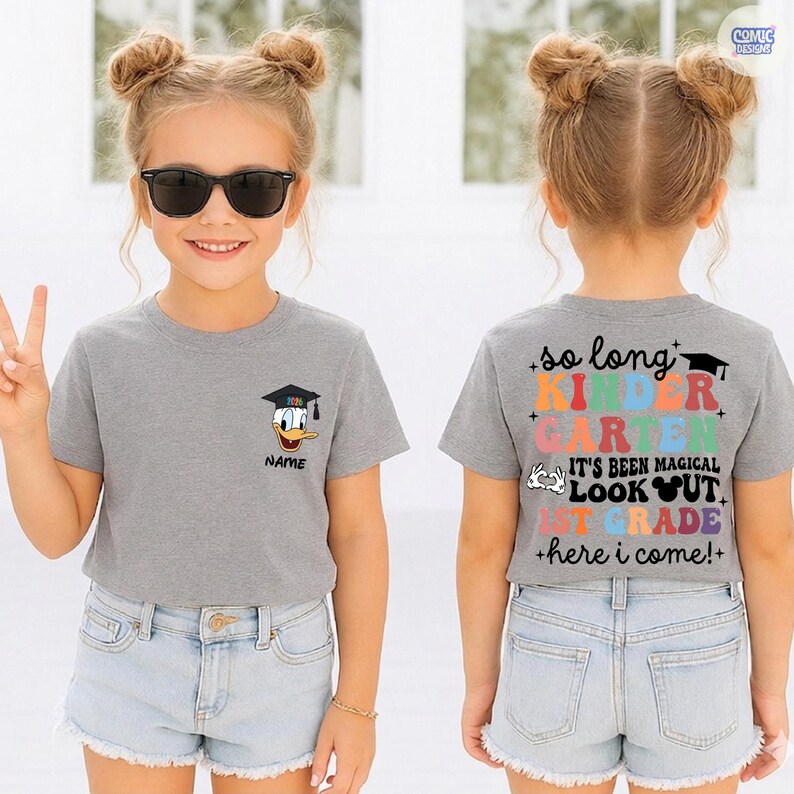 May include: A gray t-shirt with a graduation cap-wearing Donald Duck graphic and the name "NAME". The back of the shirt says "so long KINDER GARTEN...1ST GRADE +here i come!+".